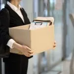 businesswoman leaving office with box of personal royalty free image 1588554305
