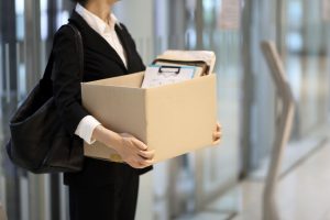 businesswoman leaving office with box of personal royalty free image 1588554305